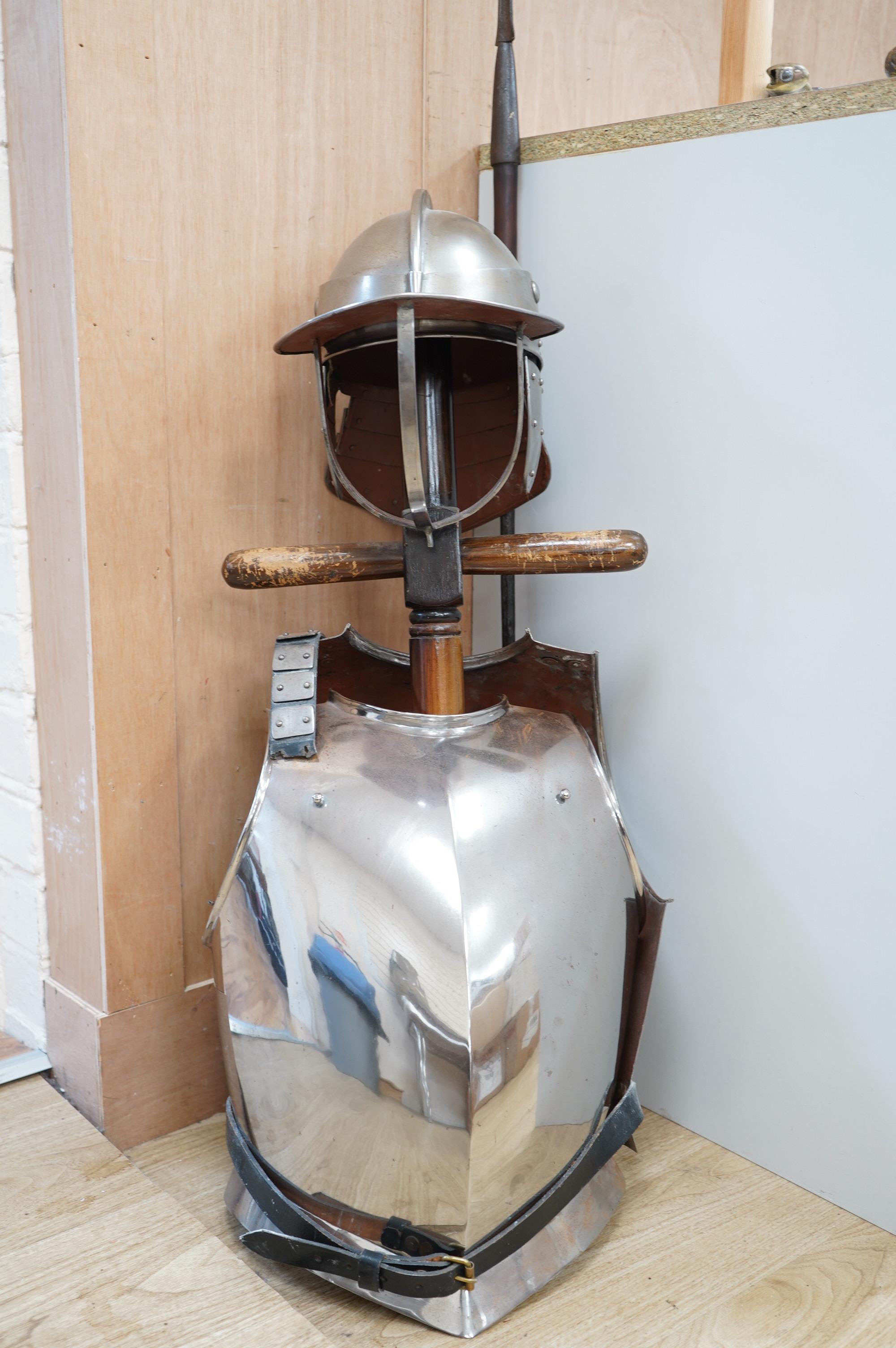 A replica suit of English Civil War armour on a stand, comprising; a lobster pot helmet, breastplate and back plate. Condition - poor to fair